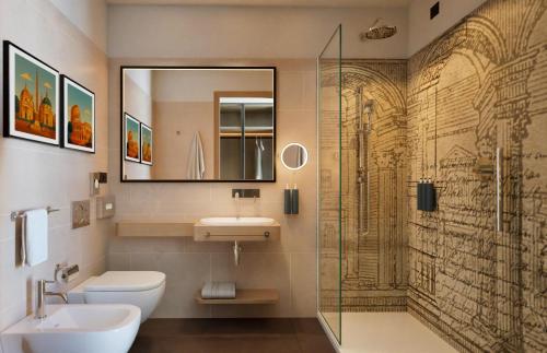 a bathroom with a toilet and a sink and a shower at Hilton Garden Inn Rome Colosseum in Rome