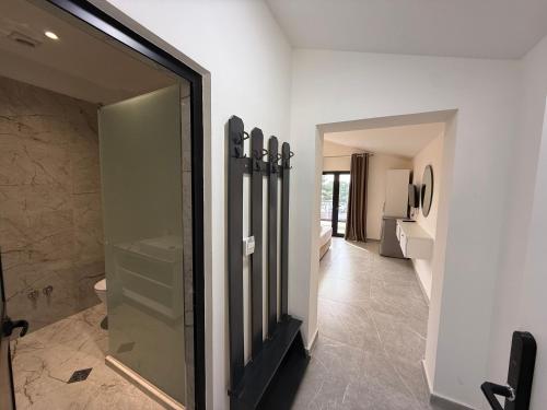 a bathroom with a walk in shower and a mirror at Molla Hotel Restorant in Shëngjin
