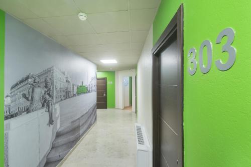 an office hallway with a green wall and a door at B&B Hotel Trieste in Trieste