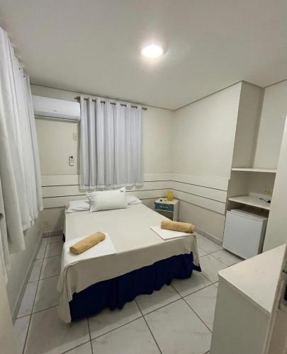 a small room with a bed and a window at Pousada Rio Doce in Olinda