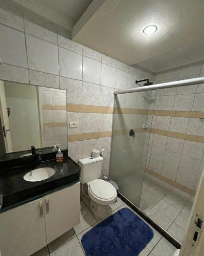 a bathroom with a toilet and a sink and a shower at Pousada Rio Doce in Olinda