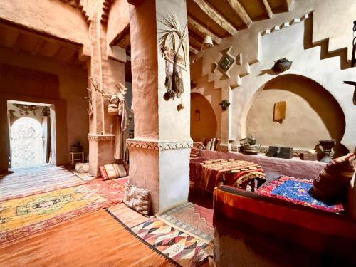 a large room with a table in a building at Kasbah Maktob Tamnougalt in Agdz