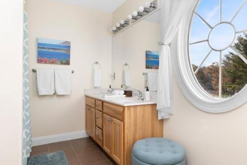 a bathroom with a sink and a window at Bay Park 32: Downtown Condo! in Traverse City