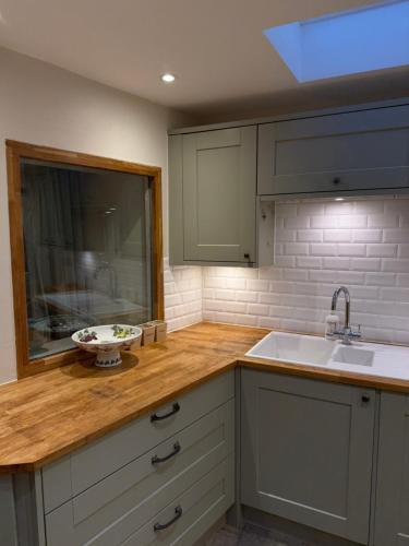a kitchen with a sink and a bowl on a counter at The Marsh Harrier B&B in Oxford