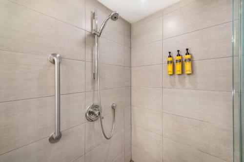 a bathroom with a shower with two fire extinguishers at Best Western Plus Ottawa City Centre in Ottawa