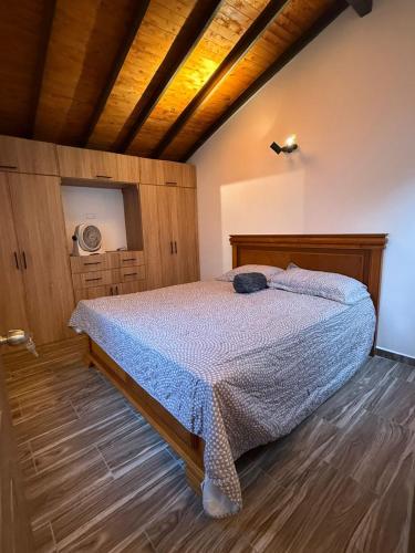 a bedroom with a bed and a wooden ceiling at Nido de Montaña Cabañas in Bello