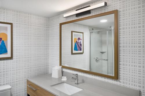 a bathroom with a sink and a mirror at Hampton Inn Chicago-Carol Stream in Carol Stream