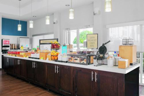 a cafeteria with a counter with food on it at Hampton Inn Lake Buena Vista / Orlando in Orlando