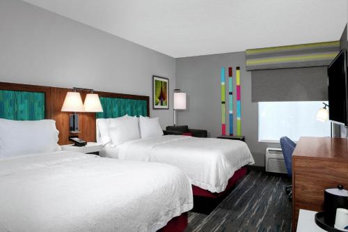 a hotel room with two beds and a television at Hampton Inn Lake Buena Vista / Orlando in Orlando