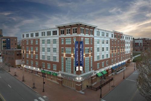 a large brick building with a blue sign on it at Hampton Inn Portland Downtown Waterfront in Portland