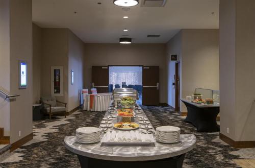 a long table with plates and food on it at DoubleTree by Hilton Hotel & Conference Centre Regina in Regina