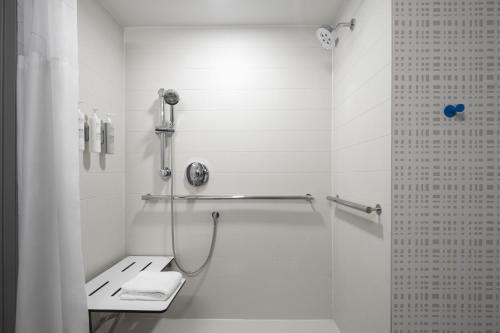 a white bathroom with a shower and a toilet at Hampton Inn - York in York