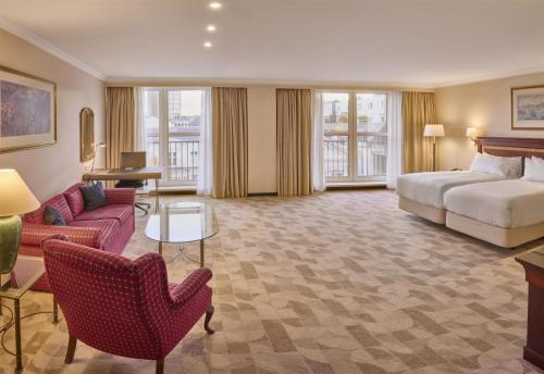 a hotel room with a bed and a couch at Hilton Antwerp Old Town in Antwerp