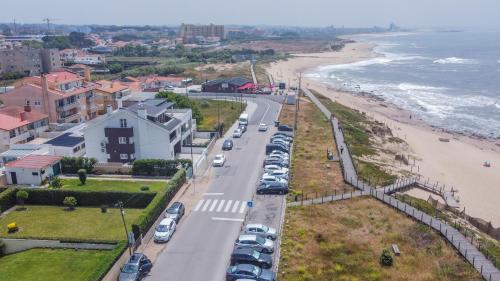 an aerial view of a beach with cars parked at Granja Beach Front in São Félix da Marinha