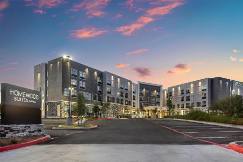 an empty parking lot in front of a building at Homewood Suites By Hilton Austin Airport in Austin