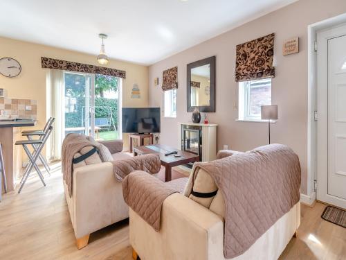 a living room with couches and a table at Ted's Place in Bridlington