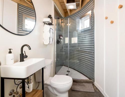 a bathroom with a shower and a toilet and a sink at Clark Farm Silos #4 - Scenic Mountain Views in Kalispell