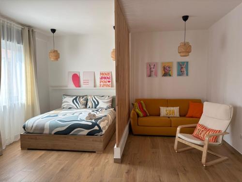 a small bedroom with a bed and a couch at Solaria House in Montesilvano