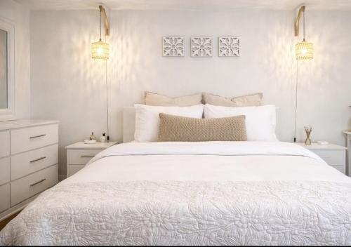 a white bedroom with a white bed and two lights at Boutique Guest Suite Private Entrance Near Hard Rock FLL Airport Cruise Port in Fort Lauderdale