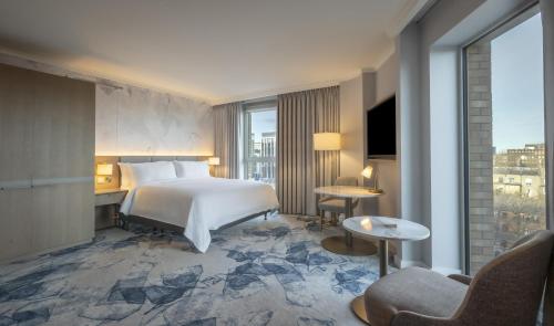 a hotel room with a bed and a large window at Hilton Dublin in Dublin