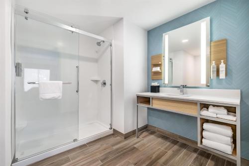 a bathroom with a shower and a sink at Hilton Garden Inn Mystic/Groton in Groton