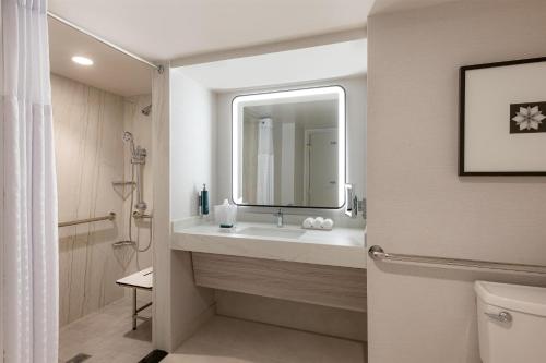 a bathroom with a sink and a mirror at Hilton Los Angeles Airport in Los Angeles