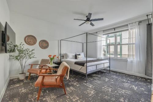 a bedroom with a bed and a table and a chair at The Orenco Station Hotel in Hillsboro