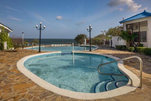 a large pool with blue water in a yard at Ph Costa Grande n6 in Nueva Gorgona