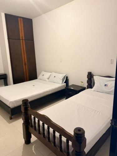 two beds in a room with two beds sidx sidx sidx at Hotel Milenium in Yopal