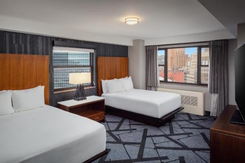 a hotel room with two beds and a window at DoubleTree by Hilton Hotel & Suites Pittsburgh Downtown in Pittsburgh