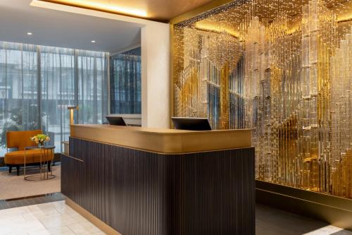 a lobby with a large wall of gold sequins at Hilton Prague Old Town in Prague
