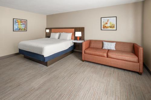 a hotel room with a bed and a couch at Hampton Inn Somerset in Somerset