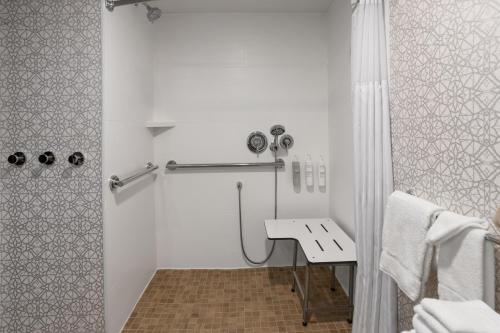 a white bathroom with a sink and a shower at Hampton Inn Somerset in Somerset