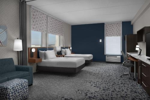 a hotel room with a bed and a couch at Home2 Suites by Hilton Arundel Mills BWI Airport in Hanover
