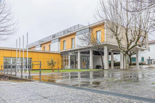 a yellow building with a tree in front of it at HI Lousã – Pousada de Juventude in Lousã