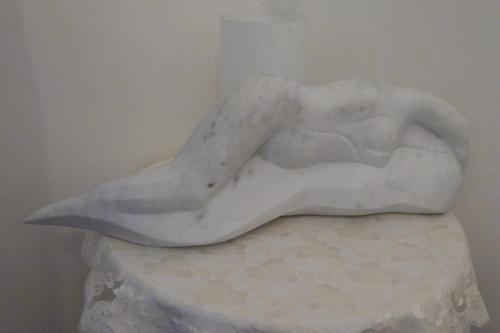 a statue of a woman laying on a table at Hotel Ristorante Radar in Carrara