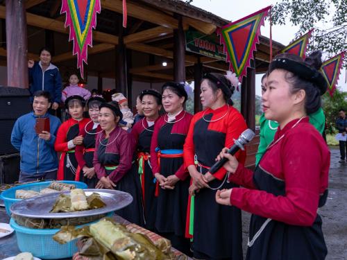 a group of women standing in front of a table of food at Đức Tới Farmstay in Ho Tô