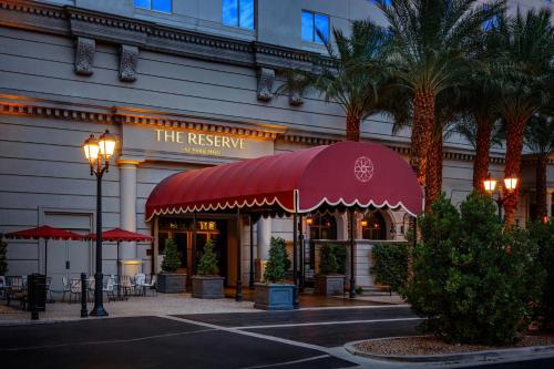a restaurant with a red awning in front of a building at The Reserve at Park MGM in Las Vegas