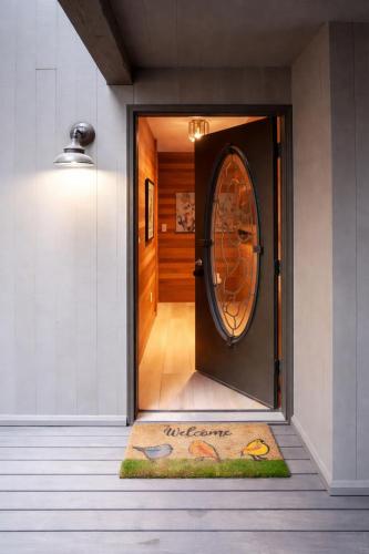 a door with a welcome mat in front of it at Glaze Meadow 129 in Redmond