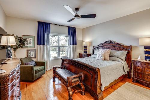 a bedroom with a bed and a ceiling fan at Spacious Getaway By Wolf Pen Gap 15 Acres and Pool! in Mena