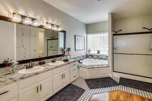 a bathroom with two sinks and a bath tub at Spacious Getaway By Wolf Pen Gap 15 Acres and Pool! in Mena