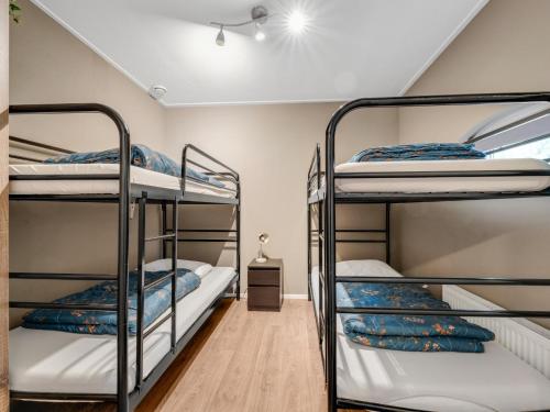 a bedroom with three bunk beds in a room at Rutershoeske in Veendam
