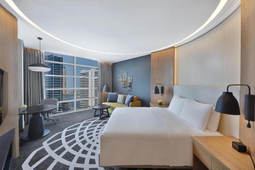 a hotel room with a large bed and a desk at DoubleTree by Hilton Dubai - Business Bay in Dubai