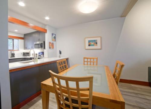 a kitchen and dining room with a table and chairs at Lodge Condo 004 in Black Butte Ranch