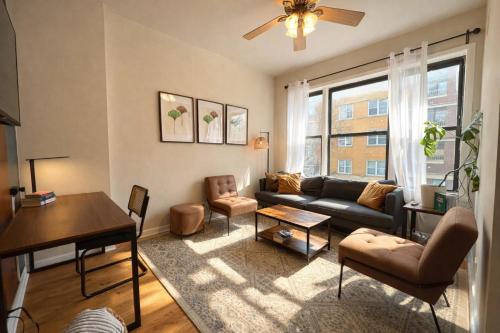 a living room with a couch and a table at Flexhome Ukrainian Village - 2BR - Convenient Walkability in Chicago
