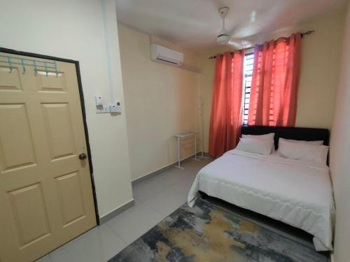a bedroom with a white bed and a red window at Seri Jerantut Homestay in Jerantut