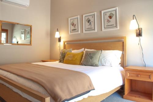 a bedroom with a bed with two lamps and a mirror at Lodge Room 016 in Black Butte Ranch