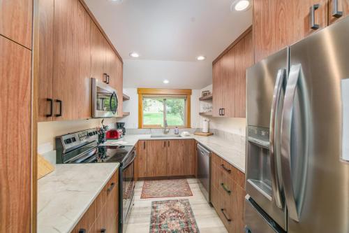 a kitchen with wooden cabinets and a stainless steel refrigerator at Lodge Condo 036 in Black Butte Ranch