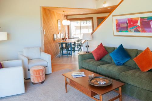 a living room with a green couch and a table at Lodge Condo 014 in Black Butte Ranch