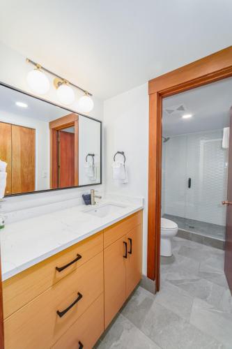 a bathroom with a sink and a mirror and a toilet at Lodge Room 018 in Black Butte Ranch